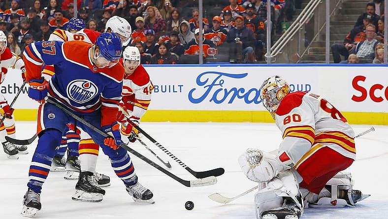 Oct 4, 2023; Edmonton, Alberta, CAN; Edmonton Oilers forward Warren Foegele (37) tries to get a shot away on Calgary Flames goaltender Dan Vladar (80) during the third period at Rogers Place. Mandatory Credit: Perry Nelson-USA TODAY Sports