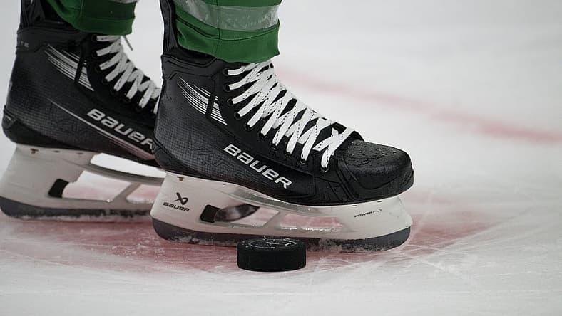 Oct 5, 2023; Dallas, Texas, USA; A view of the game puck and the face-off circle and hockey skates during the game between the Dallas Stars and the St. Louis Blues at the American Airlines Center. Mandatory Credit: Jerome Miron-USA TODAY Sports