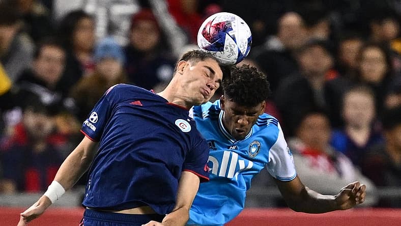 Oct 7, 2023; Chicago, Illinois, USA; Chicago Fire FC forward Georgios Koutsias (19) and Charlotte FC defender Adilson Malanda (29) battle for control of the ball in the first half at Soldier Field. Mandatory Credit: Jamie Sabau-USA TODAY Sports