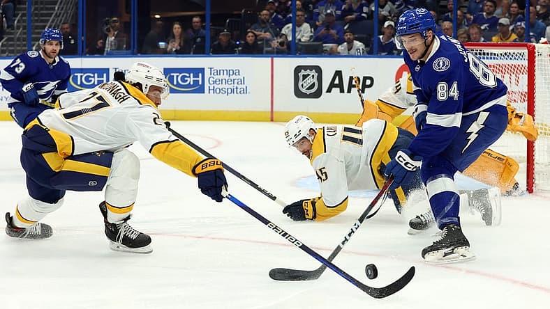 Oct 10, 2023; Tampa, Florida, USA; Tampa Bay Lightning left wing Tanner Jeannot (84) skates with the puck as Nashville Predators defenseman Ryan McDonagh (27) defends during the first period at Amalie Arena. Mandatory Credit: Kim Klement Neitzel-USA TODAY Sports