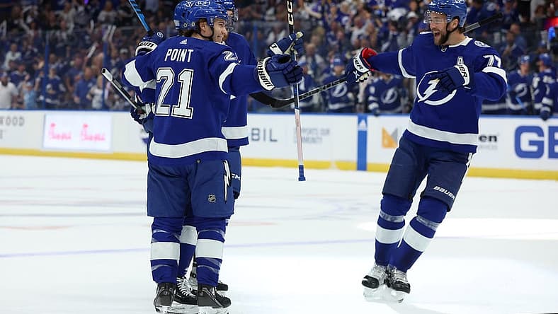 Oct 10, 2023; Tampa, Florida, USA; Tampa Bay Lightning right wing Nikita Kucherov (86) is congratulated by center Brayden Point (21) and defenseman Victor Hedman (77) after he scored a goal against the Nashville Predators during the first period at Amalie Arena. Mandatory Credit: Kim Klement Neitzel-USA TODAY Sports