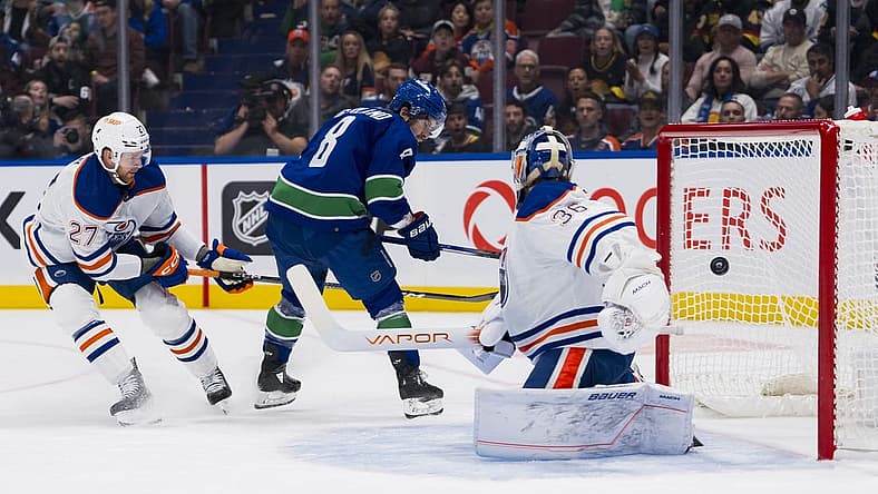 Oct 11, 2023; Vancouver, British Columbia, CAN; Edmonton Oilers defenseman Brett Kulak (27) watches as Vancouver Canucks forward Conor Garland (8) scores on goalie Jack Campbell (36) in the first period at Rogers Arena. Mandatory Credit: Bob Frid-USA TODAY Sports