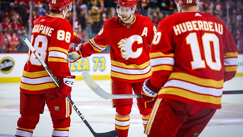 Oct 11, 2023; Calgary, Alberta, CAN; Calgary Flames center Elias Lindholm (28) celebrates his goal with teammates against the Winnipeg Jets during the third period at Scotiabank Saddledome. Mandatory Credit: Sergei Belski-USA TODAY Sports