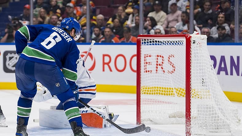 Oct 11, 2023; Vancouver, British Columbia, CAN; Vancouver Canucks forward Brock Boeser (6) scores his fourth goal of the night on Edmonton Oilers goalie Stuart Skinner (74) in the third period at Rogers Arena. Vancouver won 8-1. Mandatory Credit: Bob Frid-USA TODAY Sports