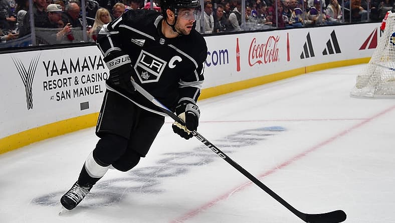 Oct 11, 2023; Los Angeles, California, USA; Los Angeles Kings center Anze Kopitar (11) moves the puck against the Colorado Avalanche during the second period at Crypto.com Arena. Mandatory Credit: Gary A. Vasquez-USA TODAY Sports