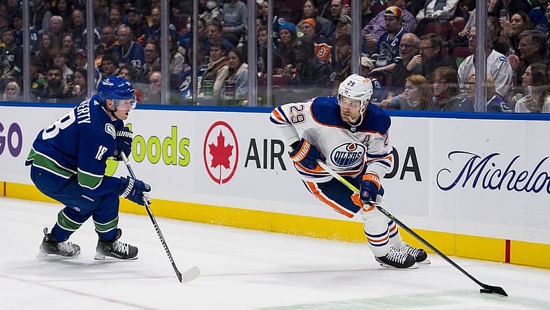 Oct 11, 2023; Vancouver, British Columbia, CAN; Vancouver Canucks forward Sam Lafferty (18) skates after Edmonton Oilers forward Leon Draisaitl (29)in the second period at Rogers Arena. Mandatory Credit: Bob Frid-USA TODAY Sports