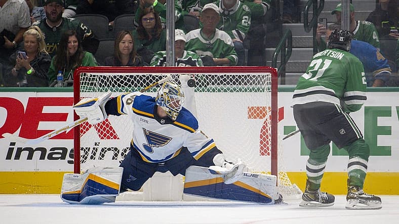 Oct 12, 2023; Dallas, Texas, USA; Dallas Stars left wing Jason Robertson (21) scores a goal against St. Louis Blues goaltender Jordan Binnington (50) during the overtime shootout period at the American Airlines Center. Mandatory Credit: Jerome Miron-USA TODAY Sports