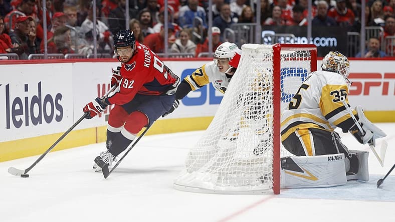 Oct 13, 2023; Washington, District of Columbia, USA; Washington Capitals center Evgeny Kuznetsov (92) skates with the puck behind Pittsburgh Penguins goaltender Tristan Jarry (35) as Penguins defenseman Ryan Graves (27) chases in the third period at Capital One Arena. Mandatory Credit: Geoff Burke-USA TODAY Sports