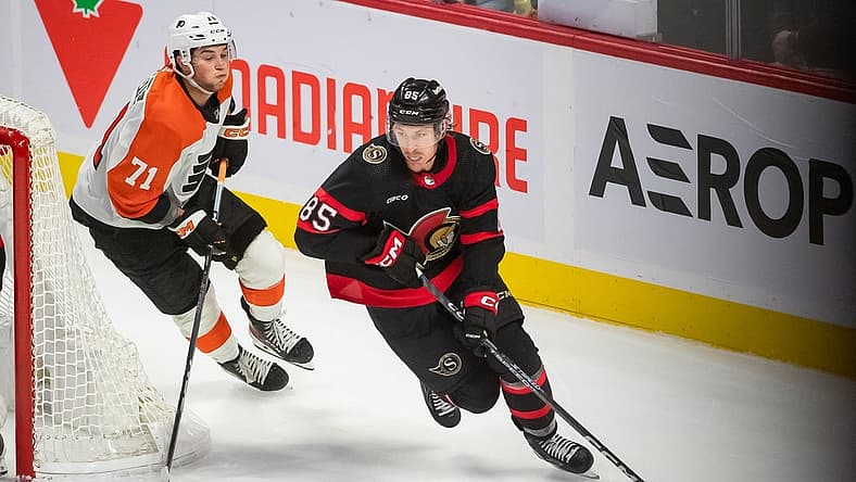 Oct 14, 2023; Ottawa, Ontario, CAN; Ottawa Senators defenseman Jake Sanderson (85) skates with the puck in front of Philadelphia Flyers right wing Tyson Foerster (71) in the third period at the Canadian Tire Centre. Mandatory Credit: Marc DesRosiers-USA TODAY Sports