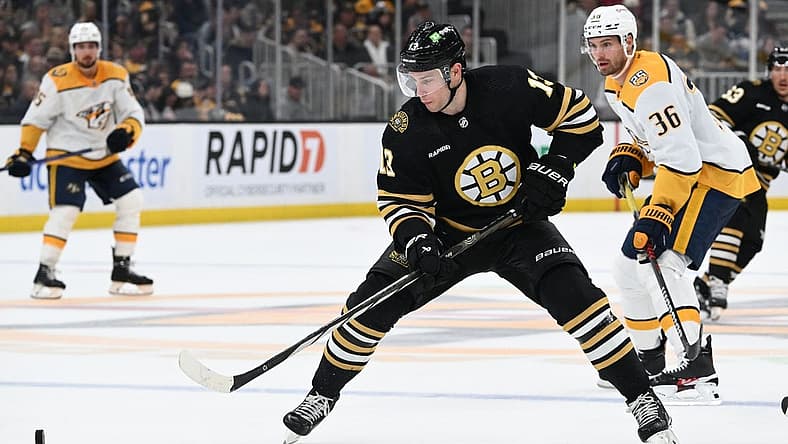Oct 14, 2023; Boston, Massachusetts, USA; Boston Bruins center Charlie Coyle (13) controls the puck against Nashville Predators left wing Cole Smith (36) during the third period at the TD Garden. Mandatory Credit: Brian Fluharty-USA TODAY Sports