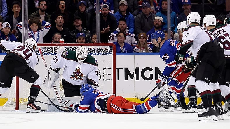 Oct 16, 2023; New York, New York, USA; New York Rangers center Vincent Trocheck (16) lunges for the puck in front of Arizona Coyotes goaltender Connor Ingram (39) during the first period at Madison Square Garden. Mandatory Credit: Brad Penner-USA TODAY Sports