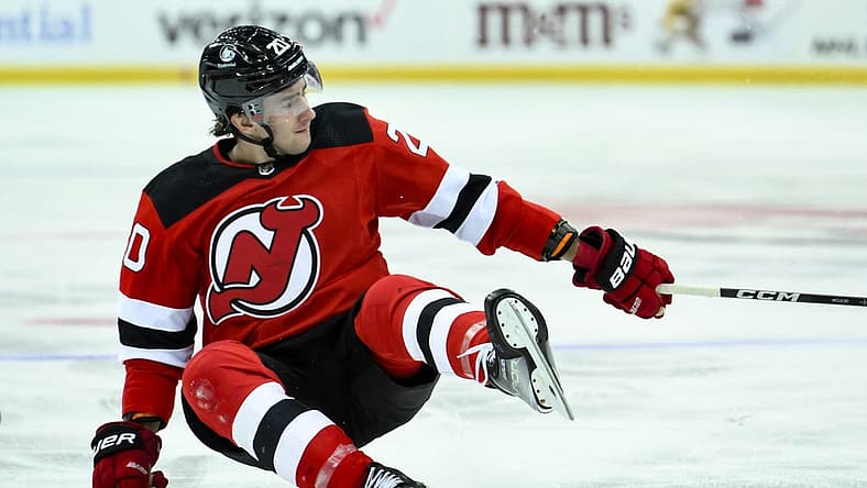 Oct 16, 2023; Newark, New Jersey, USA; New Jersey Devils center Michael McLeod (20) takes a fall against the Florida Panthers during the second period at Prudential Center. Mandatory Credit: John Jones-USA TODAY Sports