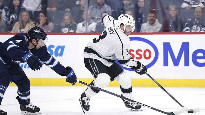 Oct 17, 2023; Winnipeg, Manitoba, CAN; Winnipeg Jets defenseman Neal Pionk (4) checks Los Angeles Kings defenseman Matt Roy (3) in the first period at Canada Life Centre. Mandatory Credit: James Carey Lauder-USA TODAY Sports