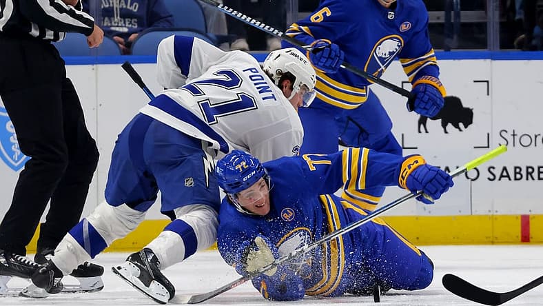 Oct 17, 2023; Buffalo, New York, USA; Tampa Bay Lightning center Brayden Point (21) knocks down Buffalo Sabres right wing Tage Thompson (72) as he plays the puck during the second period at KeyBank Center. Mandatory Credit: Timothy T. Ludwig-USA TODAY Sports