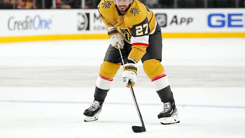 Oct 17, 2023; Las Vegas, Nevada, USA; Vegas Golden Knights defenseman Shea Theodore (27) prepares for a face off against the Dallas Stars during the third period at T-Mobile Arena. Mandatory Credit: Stephen R. Sylvanie-USA TODAY Sports