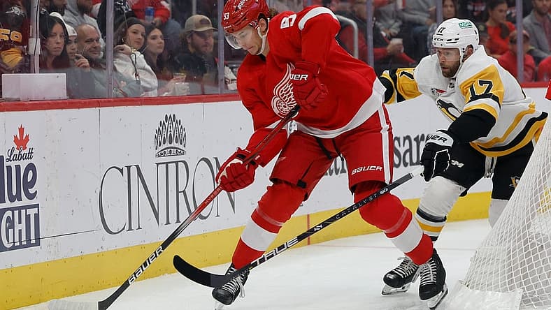 Oct 18, 2023; Detroit, Michigan, USA; Detroit Red Wings defenseman Moritz Seider (53) skates with the puck chased by Pittsburgh Penguins right wing Bryan Rust (17) in the first period at Little Caesars Arena. Mandatory Credit: Rick Osentoski-USA TODAY Sports