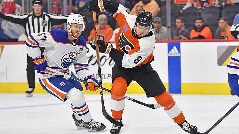 Oct 19, 2023; Philadelphia, Pennsylvania, USA; Philadelphia Flyers defenseman Cam York (8) skates with puck against Edmonton Oilers center Connor McDavid (97) during the first period at Wells Fargo Center. Mandatory Credit: Eric Hartline-USA TODAY Sports