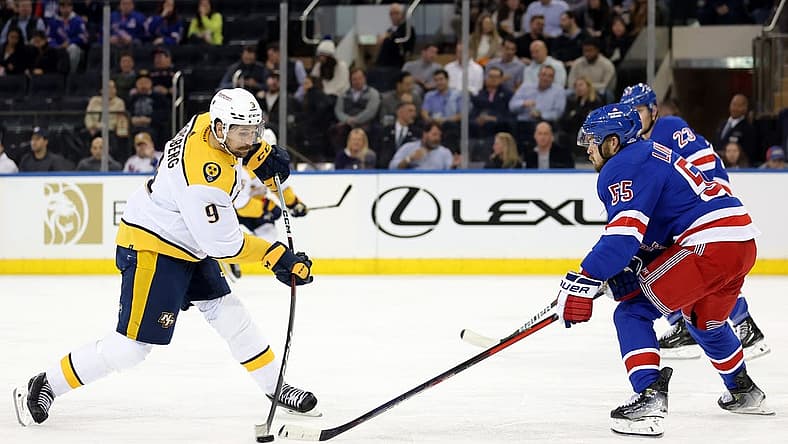 Oct 19, 2023; New York, New York, USA; Nashville Predators left wing Filip Forsberg (9) takes a shot against New York Rangers defensemen Ryan Lindgren (55) and Adam Fox (23) during the second period at Madison Square Garden. Mandatory Credit: Brad Penner-USA TODAY Sports