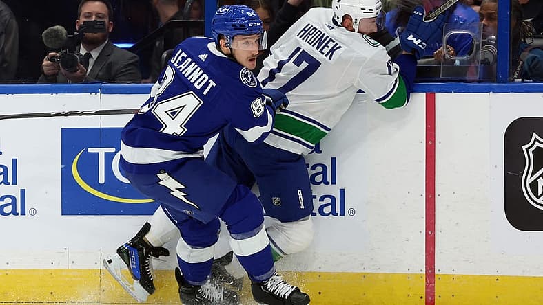Oct 19, 2023; Tampa, Florida, USA; Tampa Bay Lightning left wing Tanner Jeannot (84) defends Vancouver Canucks defenseman Filip Hronek (17) during the first period at Amalie Arena. Mandatory Credit: Kim Klement Neitzel-USA TODAY Sports