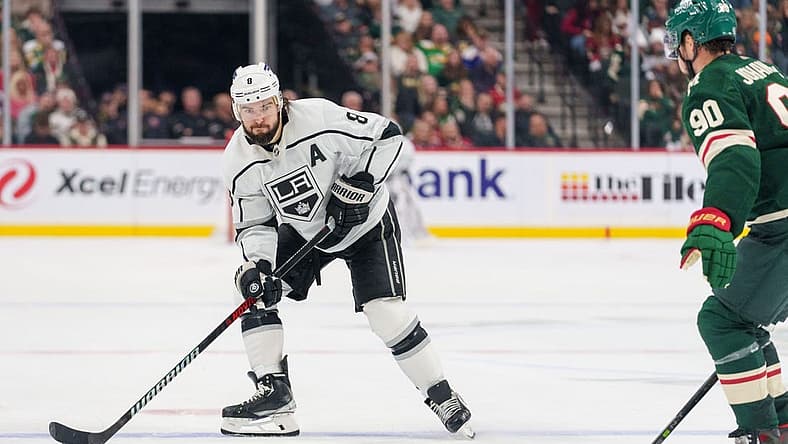 Oct 19, 2023; Saint Paul, Minnesota, USA; Los Angeles Kings defenseman Drew Doughty (8) sets up on the blue line defended by Minnesota Wild left wing Marcus Johansson (90) in the second period at Xcel Energy Center. Mandatory Credit: Matt Blewett-USA TODAY Sports
