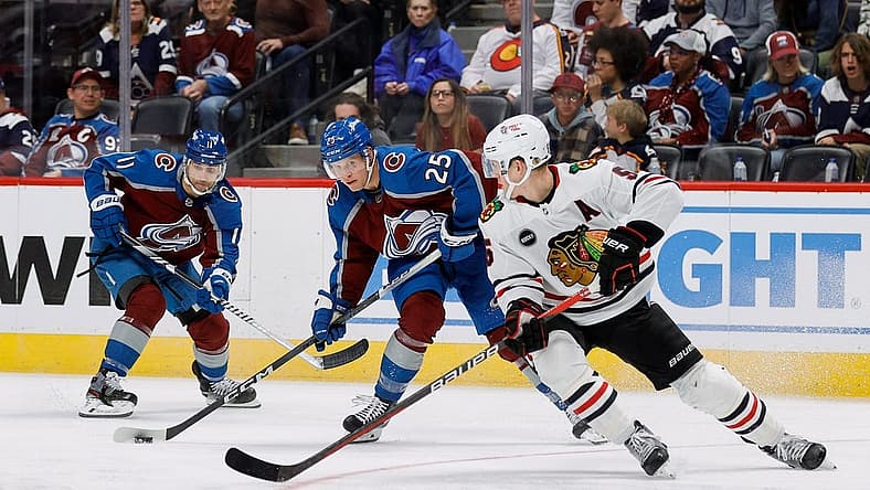 Oct 19, 2023; Denver, Colorado, USA; Colorado Avalanche right wing Logan O'Connor (25) controls the puck ahead of center Andrew Cogliano (11) as Chicago Blackhawks defenseman Connor Murphy (5) defends in the second period at Ball Arena. Mandatory Credit: Isaiah J. Downing-USA TODAY Sports