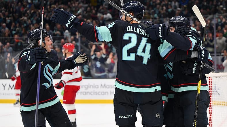 Oct 19, 2023; Seattle, Washington, USA; The Seattle Kraken celebrate after left wing Tye Kartye (52) scored a goal against the Carolina Hurricanes during the third period at Climate Pledge Arena. Mandatory Credit: Steven Bisig-USA TODAY Sports
