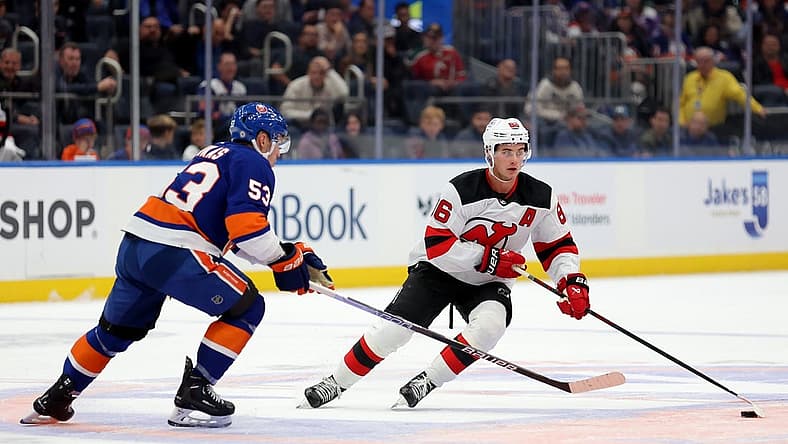 Oct 20, 2023; Elmont, New York, USA; New Jersey Devils center Jack Hughes (86) skates with the puck against New York Islanders center Casey Cizikas (53) during the first period at UBS Arena. Mandatory Credit: Brad Penner-USA TODAY Sports