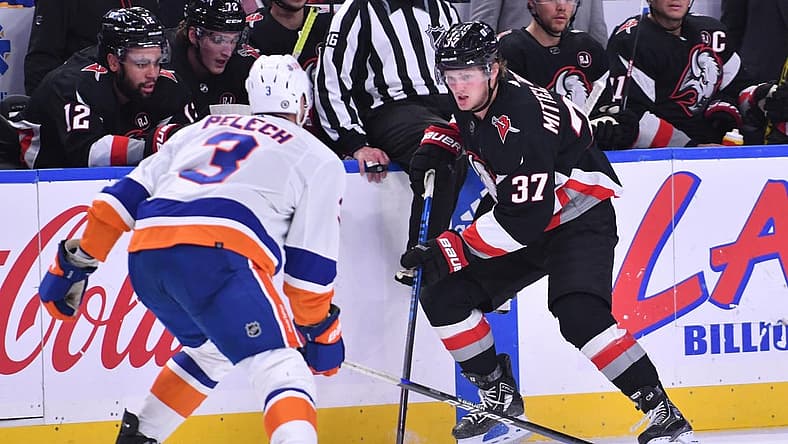 Oct 21, 2023; Buffalo, New York, USA; Buffalo Sabres center Casey Mittelstadt (37) tries to get the puck past New York Islanders defenseman Adam Pelech (3) in the second period at KeyBank Center. Mandatory Credit: Mark Konezny-USA TODAY Sports