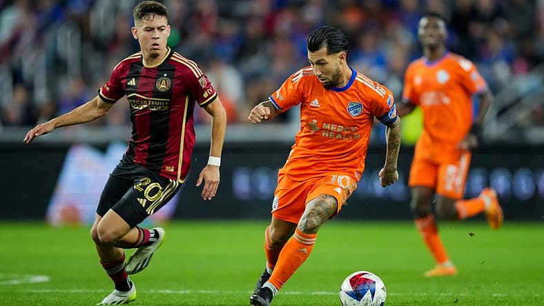 Oct 21, 2023; Cincinnati, Ohio, USA;  FC Cincinnati midfielder Luciano Acosta (10) dribbles the ball against Atlanta United FC midfielder Matheus Rossetto (20) in the second half at TQL Stadium. Mandatory Credit: Aaron Doster-USA TODAY Sports