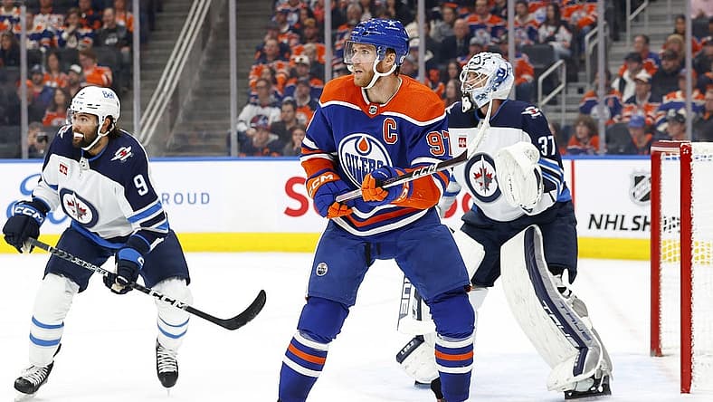 Oct 21, 2023; Edmonton, Alberta, CAN; Edmonton Oilers forward Connor McDavid (97) looks for a pass in front of Winnipeg Jets goaltender Connor Hellebuyck (37) during the first period at Rogers Place. Mandatory Credit: Perry Nelson-USA TODAY Sports