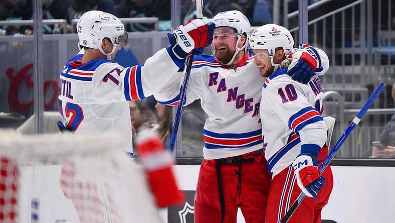 Oct 21, 2023; Seattle, Washington, USA; New York Rangers center Filip Chytil (72) and left wing Alexis Lafreniere (13) and left wing Artemi Panarin (10) celebrate after Panarin scored a goal against the Seattle Kraken during the third period at Climate Pledge Arena. Mandatory Credit: Steven Bisig-USA TODAY Sports
