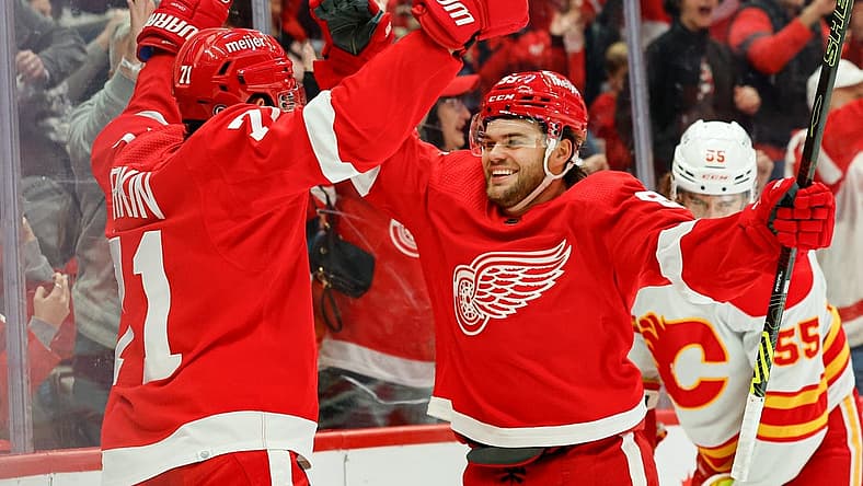 Oct 22, 2023; Detroit, Michigan, USA; Detroit Red Wings center Dylan Larkin (71) celebrates with right wing Alex DeBrincat (93) after scoring in the second period against the Calgary Flames at Little Caesars Arena. Mandatory Credit: Rick Osentoski-USA TODAY Sports