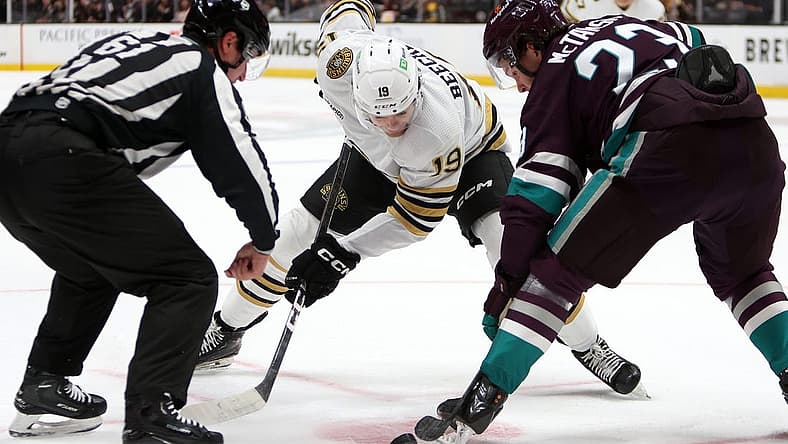 Oct 22, 2023; Anaheim, California, USA; Boston Bruins center Johnny Beecher (19) and Anaheim Ducks center Mason McTavish (23) fight for the puck at a face off during the first period at Honda Center. Mandatory Credit: Kiyoshi Mio-USA TODAY Sports
