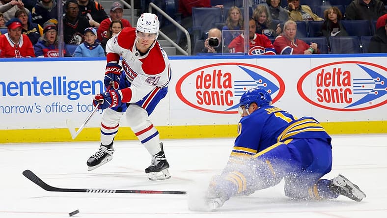 Oct 23, 2023; Buffalo, New York, USA;  Buffalo Sabres defenseman Henri Jokiharju (10) tries to block a shot by Montreal Canadiens left wing Juraj Slafkovsky (20) during the first period at KeyBank Center. Mandatory Credit: Timothy T. Ludwig-USA TODAY Sports