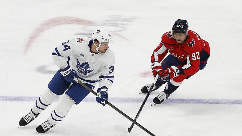 Oct 24, 2023; Washington, District of Columbia, USA; Toronto Maple Leafs center Auston Matthews (34) skates with the puck as Washington Capitals center Evgeny Kuznetsov (92) chases in the first period at Capital One Arena. Mandatory Credit: Geoff Burke-USA TODAY Sports