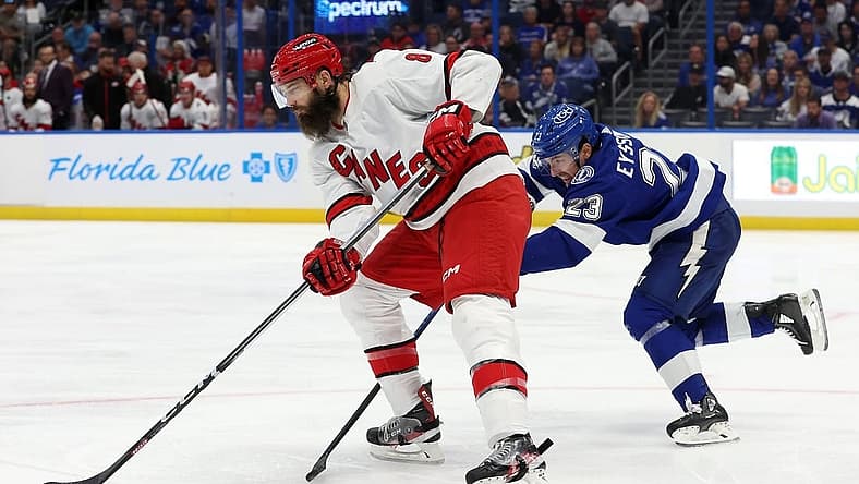 Oct 24, 2023; Tampa, Florida, USA; Carolina Hurricanes defenseman Brent Burns (8) skates with the puck as Tampa Bay Lightning center Michael Eyssimont (23)] defends during the third period at Amalie Arena. Mandatory Credit: Kim Klement Neitzel-USA TODAY Sports