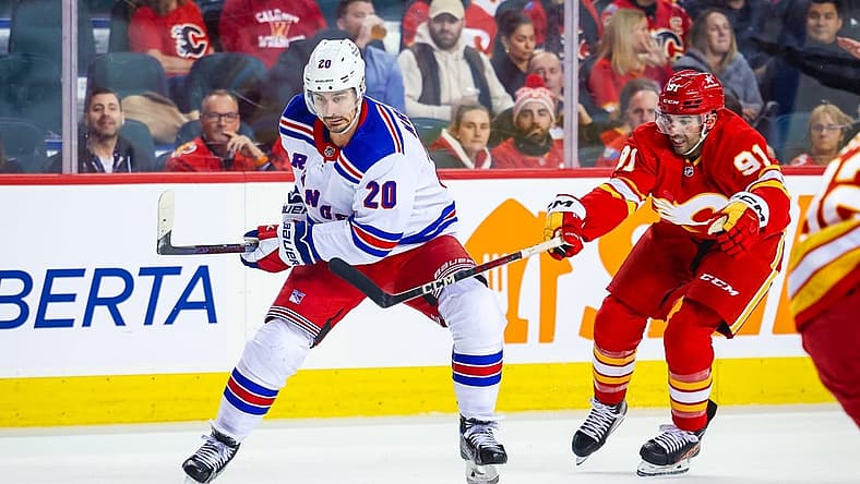 Oct 24, 2023; Calgary, Alberta, CAN; New York Rangers left wing Chris Kreider (20) controls the puck in front of Calgary Flames center Nazem Kadri (91) during the first period at Scotiabank Saddledome. Mandatory Credit: Sergei Belski-USA TODAY Sports