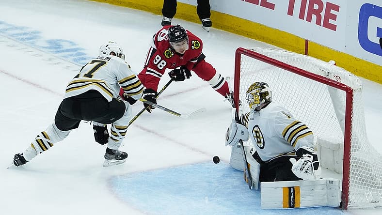 Oct 24, 2023; Chicago, Illinois, USA; Boston Bruins goaltender Jeremy Swayman (1) makes a save on Chicago Blackhawks center Connor Bedard (98) during the second period at United Center. Mandatory Credit: David Banks-USA TODAY Sports