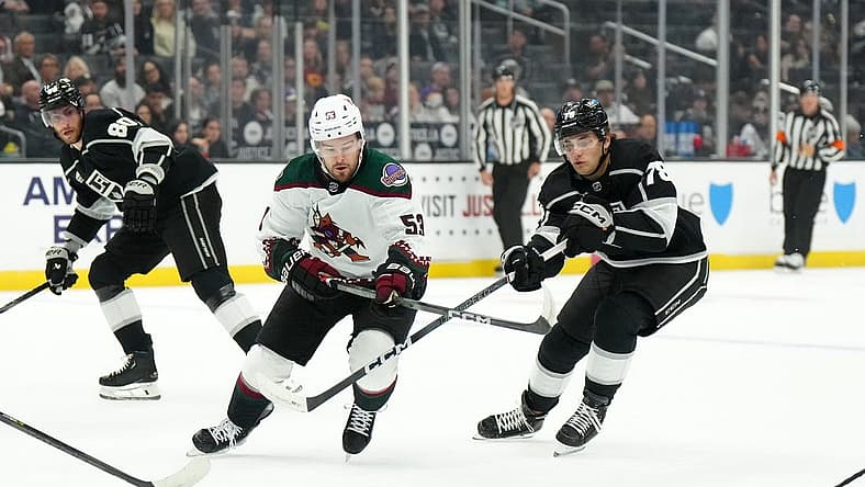 Oct 24, 2023; Los Angeles, California, USA; Arizona Coyotes left wing Michael Carcone (53) and LA Kings right wing Alex Laferriere (78) battle for the puck in the first period at Crypto.com Arena. Mandatory Credit: Kirby Lee-USA TODAY Sports