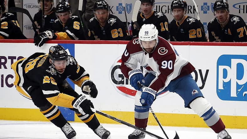 Oct 26, 2023; Pittsburgh, Pennsylvania, USA; Pittsburgh Penguins defenseman Marcus Pettersson (28) defends Colorado Avalanche left wing Tomas Tatar (90) during the first period at PPG Paints Arena. Mandatory Credit: Charles LeClaire-USA TODAY Sports
