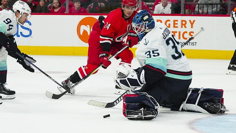 Oct 26, 2023; Raleigh, North Carolina, USA; Carolina Hurricanes center Seth Jarvis (24) scoring attempt is stopped by Seattle Kraken goaltender Joey Daccord (35) during the first period at PNC Arena. Mandatory Credit: James Guillory-USA TODAY Sports