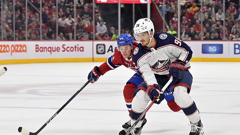 Oct 26, 2023; Montreal, Quebec, CAN; Columbus Blue Jackets forward Jack Roslovic (96) plays the puck and Montreal Canadiens defenseman Jordan Harris (54) defends during the first period at the Bell Centre. Mandatory Credit: Eric Bolte-USA TODAY Sports