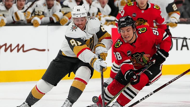 Oct 27, 2023; Las Vegas, Nevada, USA; Vegas Golden Knights right wing Jonathan Marchessault (81) chops the puck away from Chicago Blackhawks center Connor Bedard (98) during the first period at T-Mobile Arena. Mandatory Credit: Stephen R. Sylvanie-USA TODAY Sports
