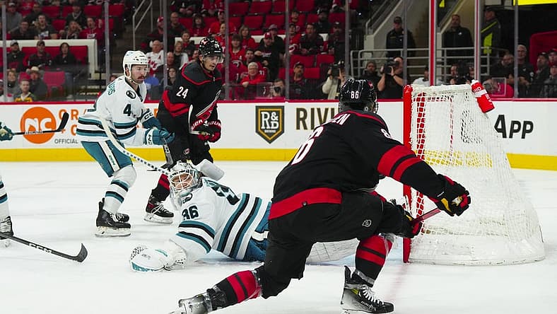 Oct 27, 2023; Raleigh, North Carolina, USA; Carolina Hurricanes left wing Teuvo Teravainen (86) scores a goal past San Jose Sharks goaltender Kaapo Kahkonen (36) during the first period at PNC Arena. Mandatory Credit: James Guillory-USA TODAY Sports