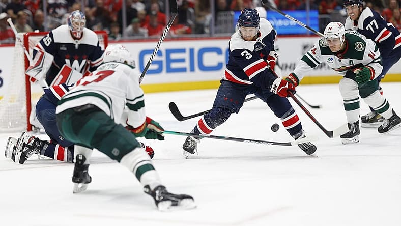 Oct 27, 2023; Washington, District of Columbia, USA; Washington Capitals defenseman Nick Jensen (3) clears the puck from Minnesota Wild center Joel Eriksson Ek (14) in the second period at Capital One Arena. Mandatory Credit: Geoff Burke-USA TODAY Sports