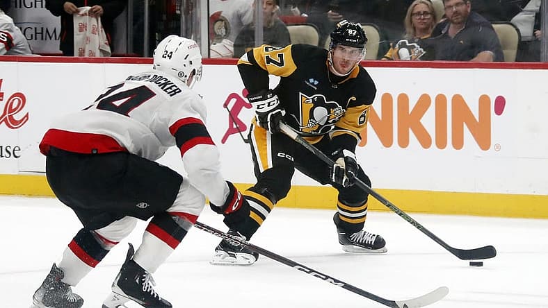 Oct 28, 2023; Pittsburgh, Pennsylvania, USA; Pittsburgh Penguins center Sidney Crosby (87) carries the puck as Ottawa Senators defenseman Jacob Bernard-Docker (24) defends during the first period at PPG Paints Arena. Mandatory Credit: Charles LeClaire-USA TODAY Sports
