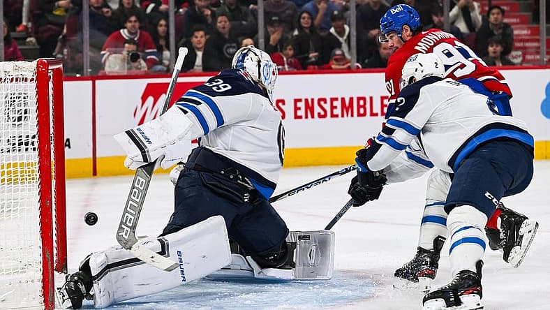 Oct 28, 2023; Montreal, Quebec, CAN; Winnipeg Jets goalie Laurent Brossoit (39) gives a goal to Montreal Canadiens center Sean Monahan (91) during the second period at Bell Centre. Mandatory Credit: David Kirouac-USA TODAY Sports
