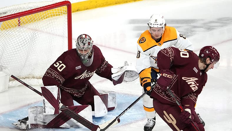 Mar 9, 2023; Tempe, Arizona, USA; Arizona Coyotes Ivan Prosvetov (50) makes a save in front of Nashville Predators center Cody Glass (8) during the third period at Mullett Arena. Mandatory Credit: Joe Camporeale-USA TODAY Sports
