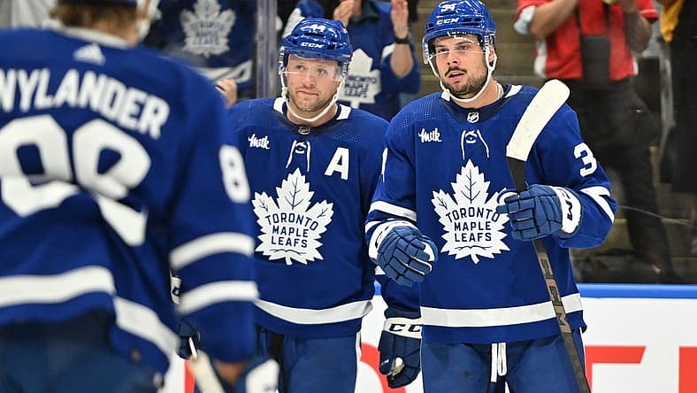 Oct 5, 2023; Toronto, Ontario, CAN; Toronto Maple Leafs forward Auston Matthews (34) celebrates with defenseman Morgan Rielly (44) and forward William Nylander (88) after scoring a goal against the Detroit Red Wings in the first period at Scotiabank Arena. Mandatory Credit: Dan Hamilton-USA TODAY Sports