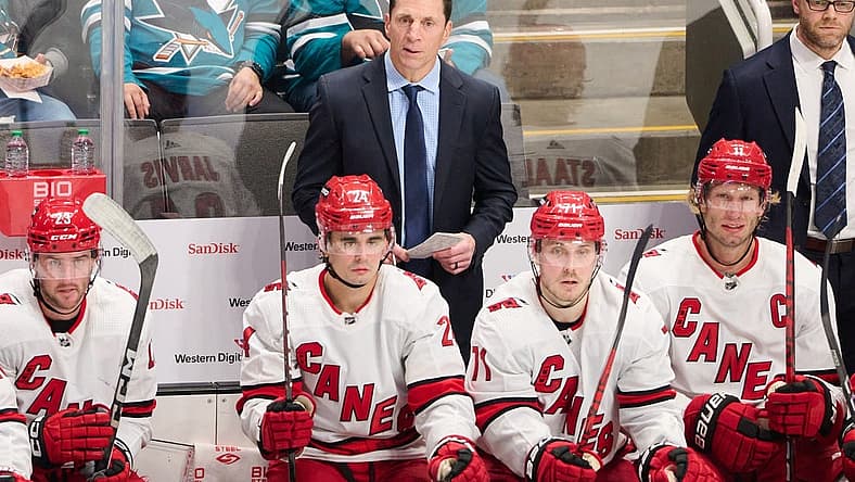 Oct 17, 2023; San Jose, California, USA; Carolina Hurricanes head coach Rod Brind'Amour watches the game from behind the bench against the San Jose Sharks during the third period at SAP Center at San Jose. Mandatory Credit: Robert Edwards-USA TODAY Sports